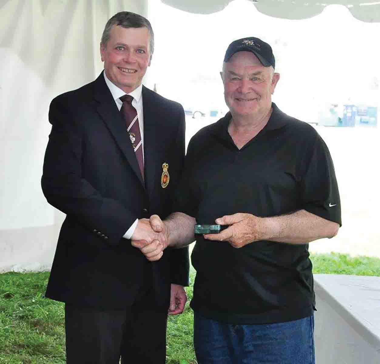 Sandy Post receiving the bronze for the 1,000-yard Match from Don Haisell.